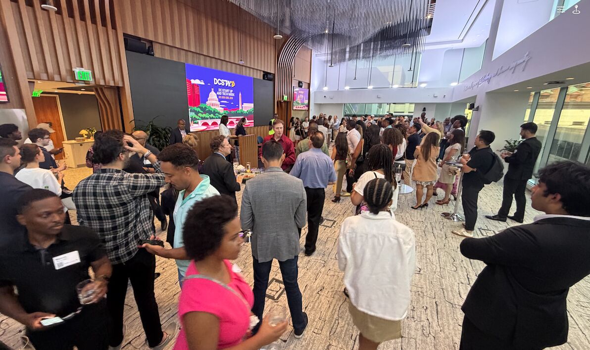Attendees exploring exhibits at a tech event